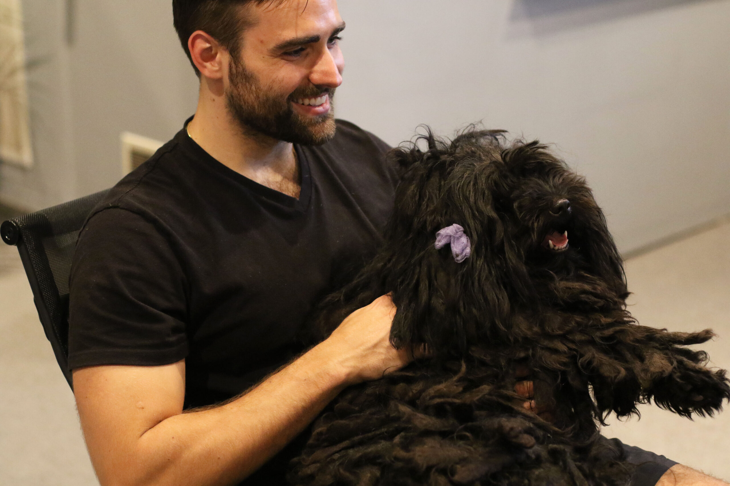 Happy employee playing with puppy